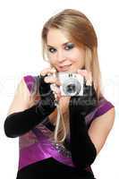 Playful blonde holding a photo camera. Isolated