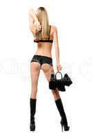 Sexy young blonde with handbag and bottle in her hands