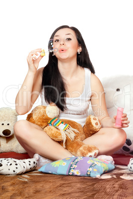 Playful pretty girl blow bubbles. Isolated