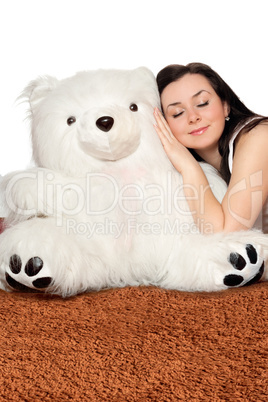 Girl asleep leaning against a teddy bear