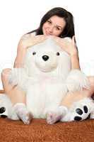 Beautiful girl sitting in an embrace with a teddy bear