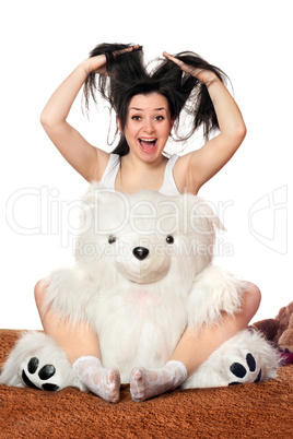 Joyful girl with a teddy bear
