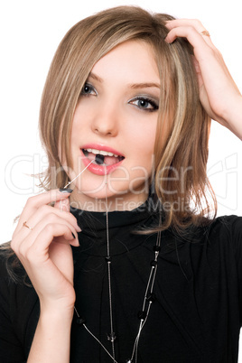Portrait of beautiful girl with a bead in her mouth