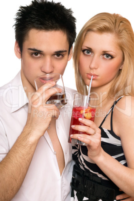 Pretty young couple with cocktails. Isolated