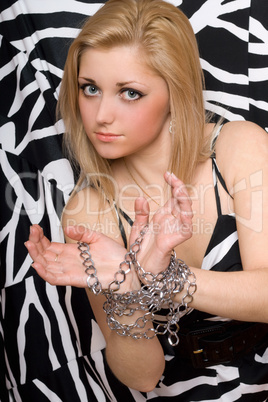 Attractive woman stretches out her hands in chains