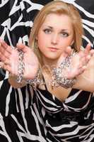 pretty blonde stretches out her hands in chains