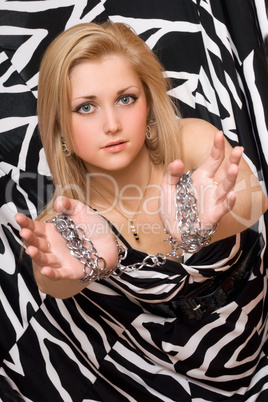 attractive blonde stretches out her hands in chains