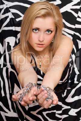 sexy woman stretches out her hands in chains