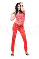 Smiling young brunette in a red jeans