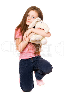 Happy little girl with a teddy elephant
