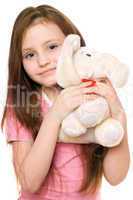 Portrait of little girl with a teddy elephant