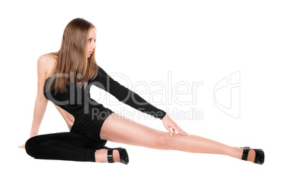 Leggy young woman in a black tight-fitting body suit dance