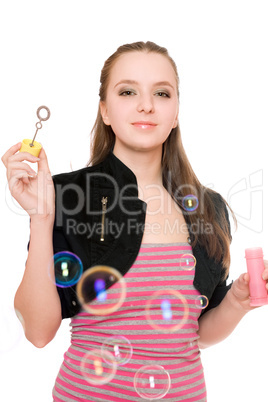 Portrait of smiling young woman blow bubbles