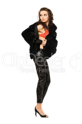 Beautiful young brunette in black coat and leggings