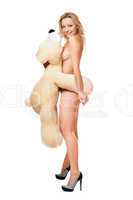 naked young woman with large teddy bear