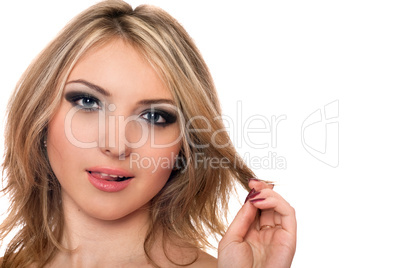 Closeup portrait of playful beautiful young blonde