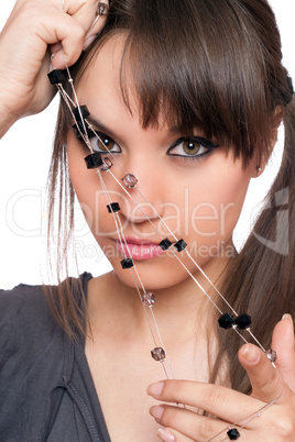 Closeup portrait of pretty brunette with a beads