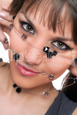 Closeup portrait of young brunette with a bead