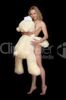 Pretty naked young woman posing with large teddy bear
