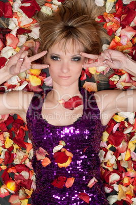 attractive young blonde lying in rose petals