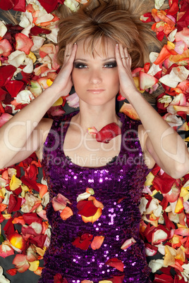 lovely young blonde lying in rose petals