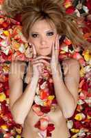 pretty blonde lying in rose petals