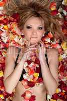 beautiful blonde lying in rose petals