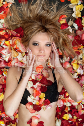 attractive blonde lying in rose petals