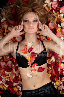 sensual blonde lying in rose petals