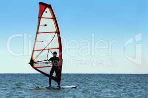 Silhouette of a windsurfer on the sea