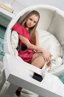 girl siting in a white chair