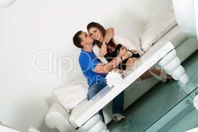 couple siting on a white sofa