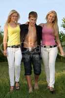 Two beautiful blonde and young man walking