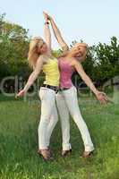 Two happy attractive blonde in white jeans
