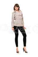Charming girl wearing a coat and black leggings. Isolated
