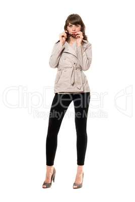 Sexy girl wearing a coat and black leggings. Isolated