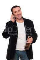 Smiling man with a phone and bottle of scotch