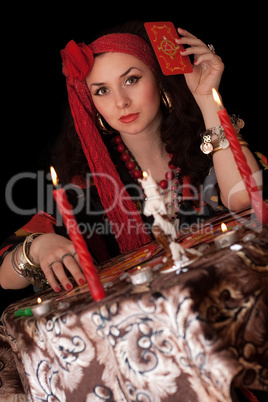 Gypsy woman sitting with cards. Isolated