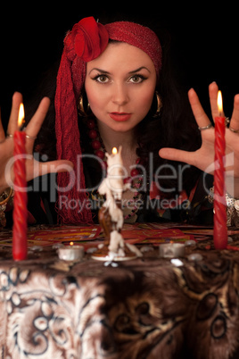 Witch at the table with candles. Isolated
