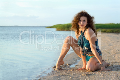 Beautiful young woman sitting on the bay