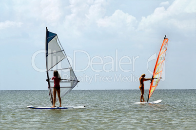 Two girls windsurfers