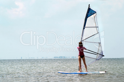 Silhouette of a girl windsurfer