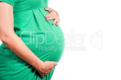 Belly of a pregnant girl in green dress