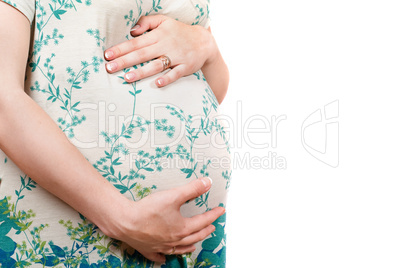 Belly of a pregnant girl in dress. Isolated