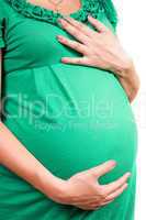 Belly of a pregnant girl in green dress. Isolated