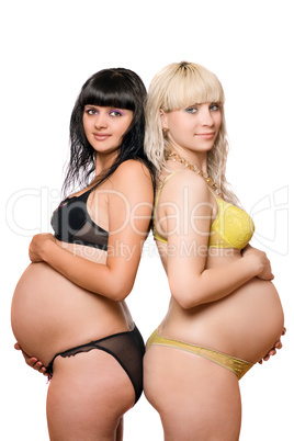 Pregnant blonde and brunette. Isolated on white