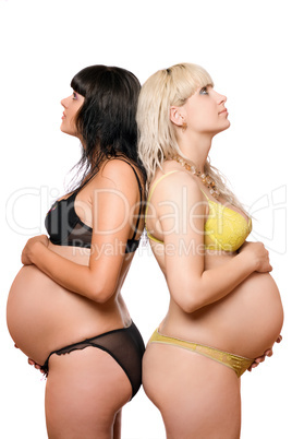 Two pregnant young women. Isolated on white
