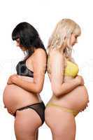 Two pregnant young women. Isolated