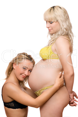 Pregnant woman with the smiling girlfriend