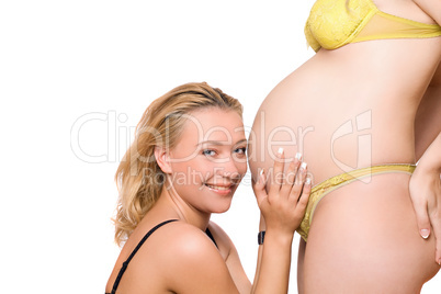 Smiling woman and belly of pregnant girlfriend